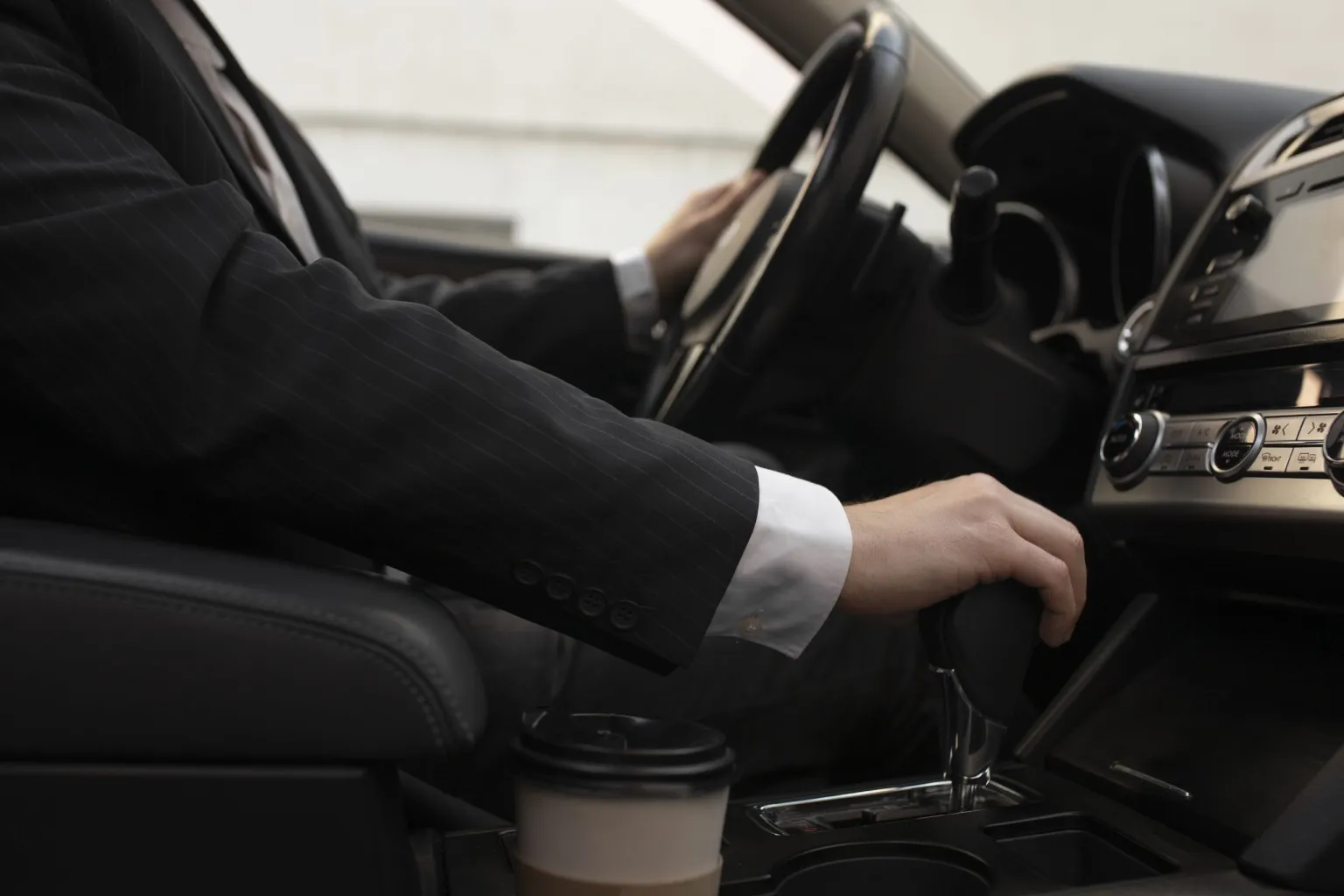 man-using-his-car-s-options-while-driving-scaled